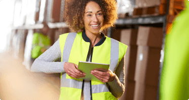 Person in safety vest smiling.