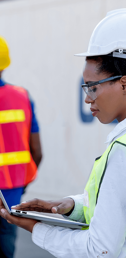 A woman in the field services industry is looking at digital form options from GoCanvas on a laptop.