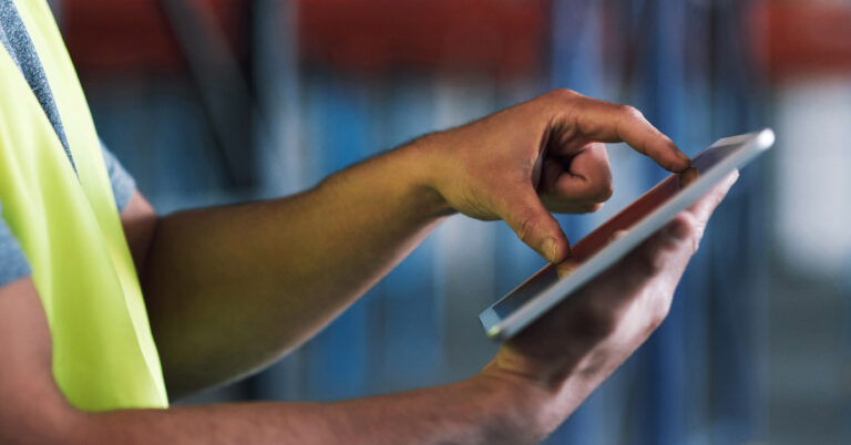 A person uses two fingers to zoom on their digital tablet.