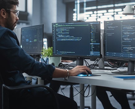 Image of developers at computer for GoCanvas SDK checklist webpage hero.